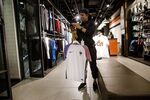 An employee holds an official French national football team jersey inside the Nike Inc. sports apparel store in Paris, France, on Thursday, May 19, 2016.