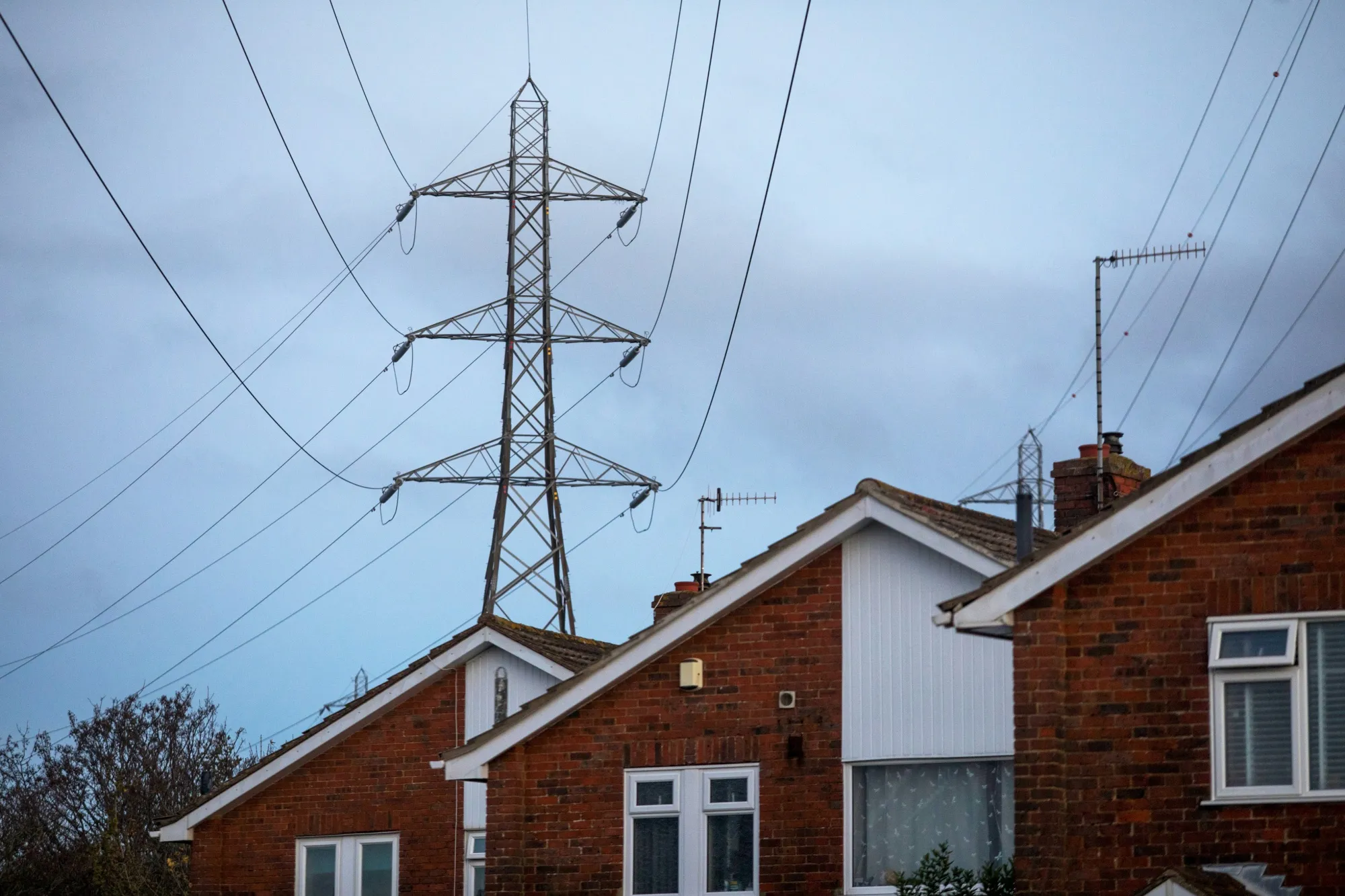 An electricity transmission pylon above residential houses in Brighton.