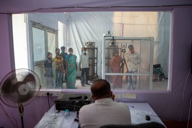 Dr. Asad Khan, screening new Covid positive cases from Dharavi through a safety isolation booth set up at the DCHC (Dedicated Covid Health Center) located at the Sion Bandra Link Road, Mumbai. 10th July 2020.