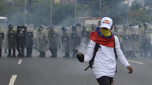 Protester holds tear gas on May 11.