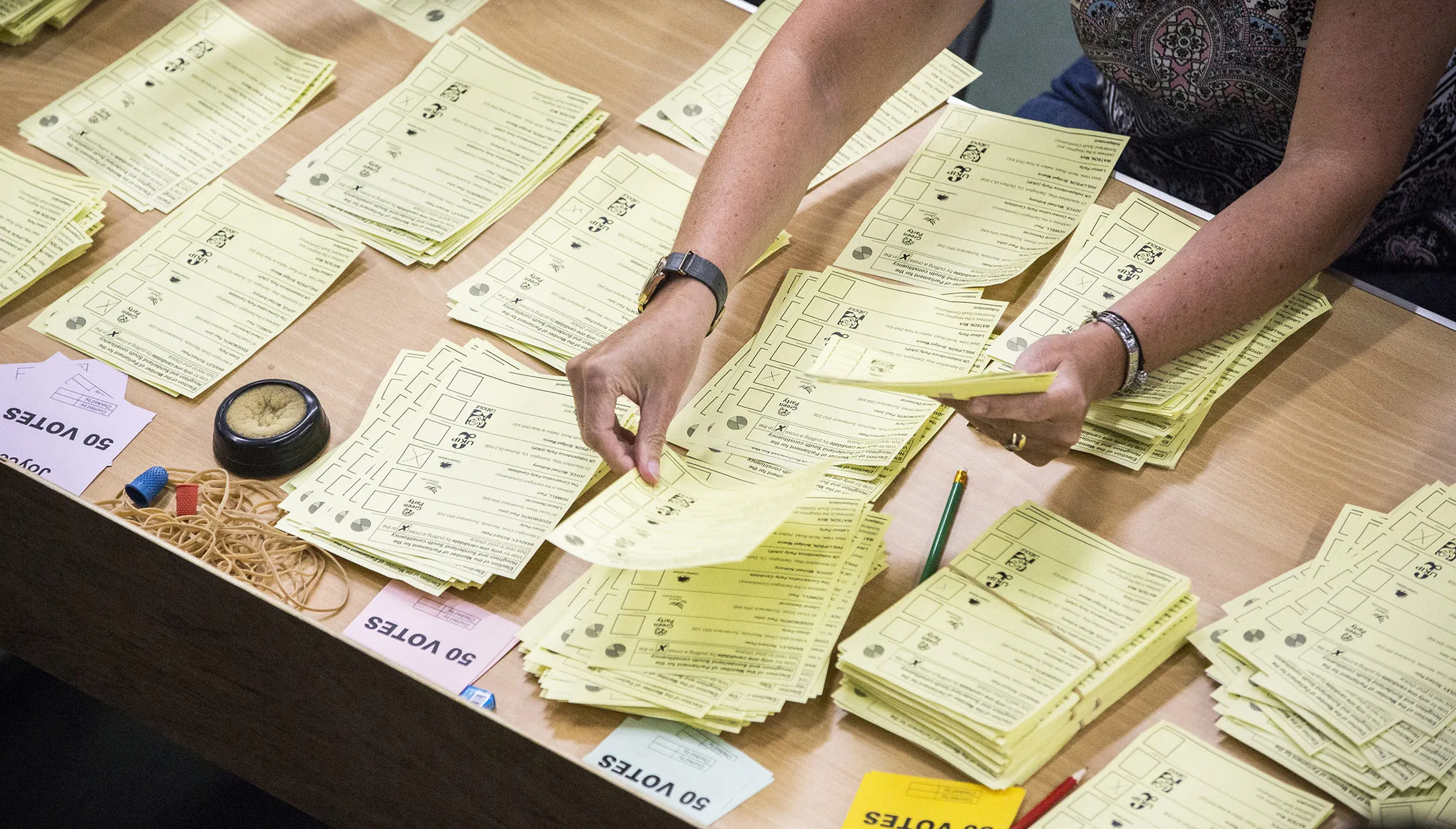 Volunteers count ballot papers for three constituencies in Tyne and Wear ceremonial county at the Silksworth Community Pool, Tennis and Wellness Centre in Sunderland, U.K., on Thursday, June 8, 2017. Britons voted today after an election dominated by Brexit, austerity and in the closing phases, security.
