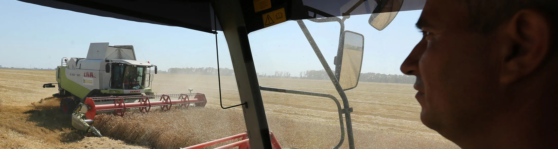 A worker operates the controls of a combine harvester, manufactured by Claas KGaA, during the summer wheat harvest on a farm operated by Kuban Agroholding, a unit of Basic Element Co., in Ust-Labinsk, Russia, on Monday, June 27, 2016. Russian wheat-export prices dropped to a six-year low last week as prices in major competitors such as the U.S. and France fell and harvesting of a bumper crop was about to start.
