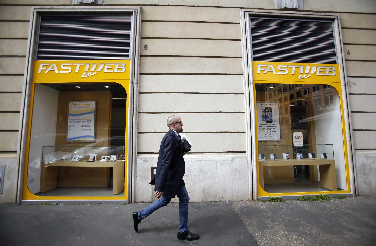 A pedestrian walks past a Fastweb store&nbsp;in Rome, Italy.