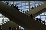 Attendees ride an escalator inside an exhibition hall&nbsp;in San Francisco.