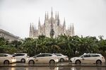 Taxis outside the Duomo Cathedral in Milan, Italy.