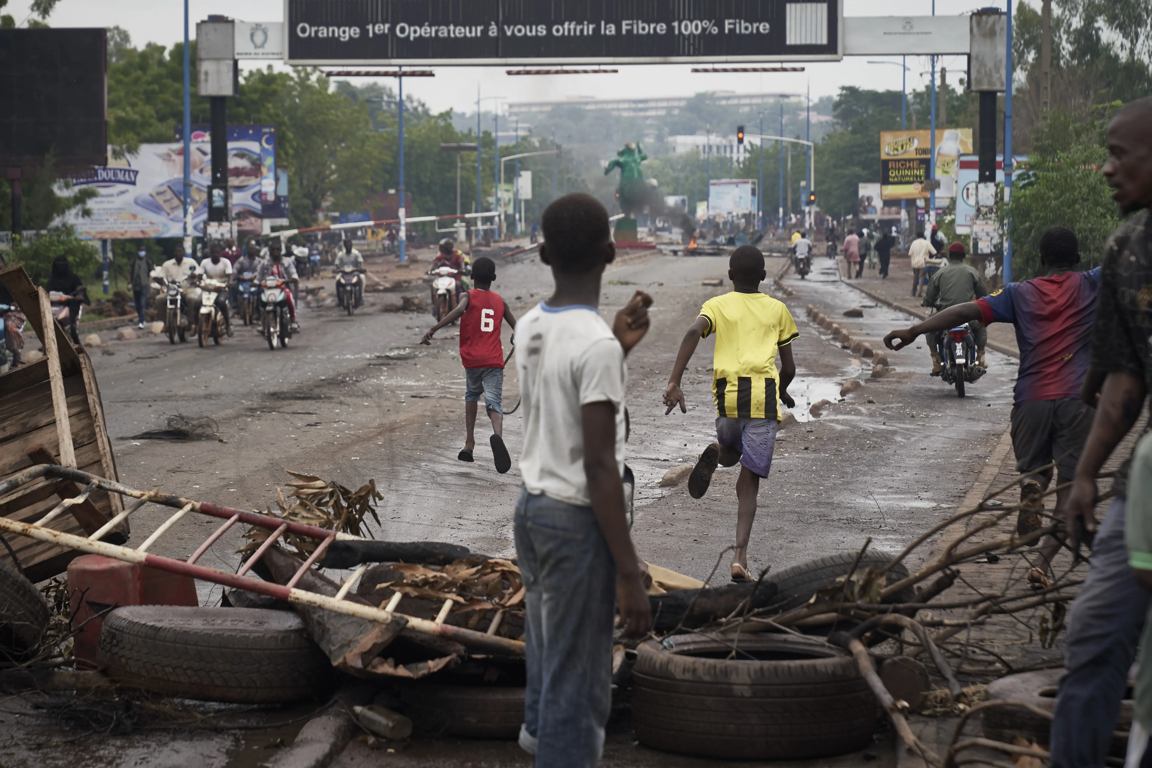 People run away at the arrival of the riot police in Bamako on July 11.