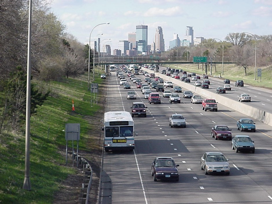 A Minnesota Valley transit bus uses the shoulder on I-35W, outside Minneapolis; some of the fleet uses lane-assist technology.