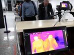 Travellers queue in front of a thermal scanner upon their arrival at the Murtala Mohammed International Airport in Lagos, Nigeria, on Jan. 27, 2019.