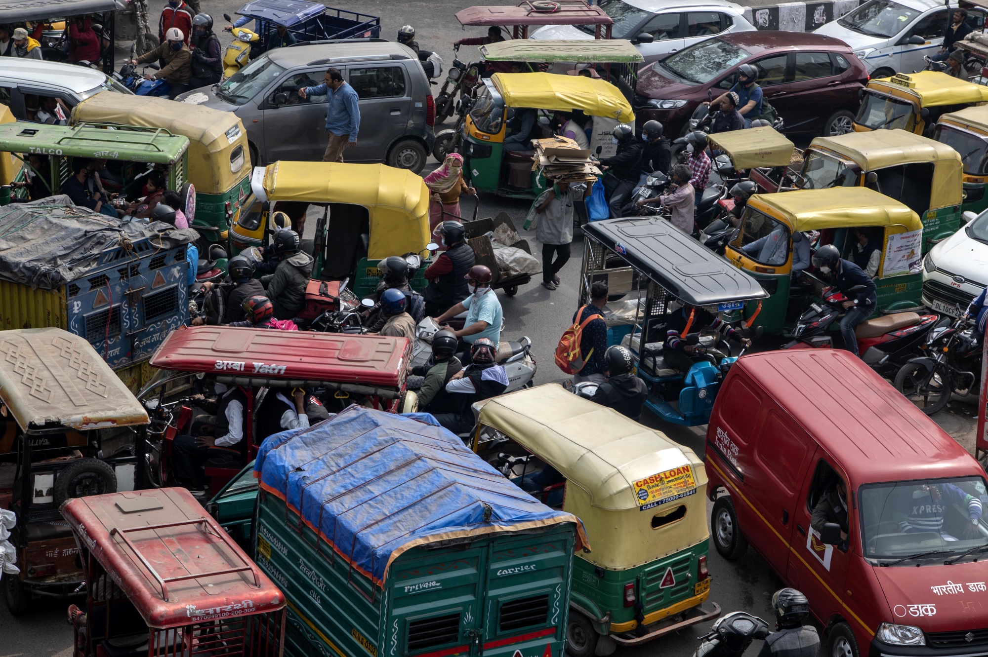 Various means of transportation, including electric rickshaw are stuck in a traffic snarl in New Delhi, India on Wednesday, February 23, 2022. 