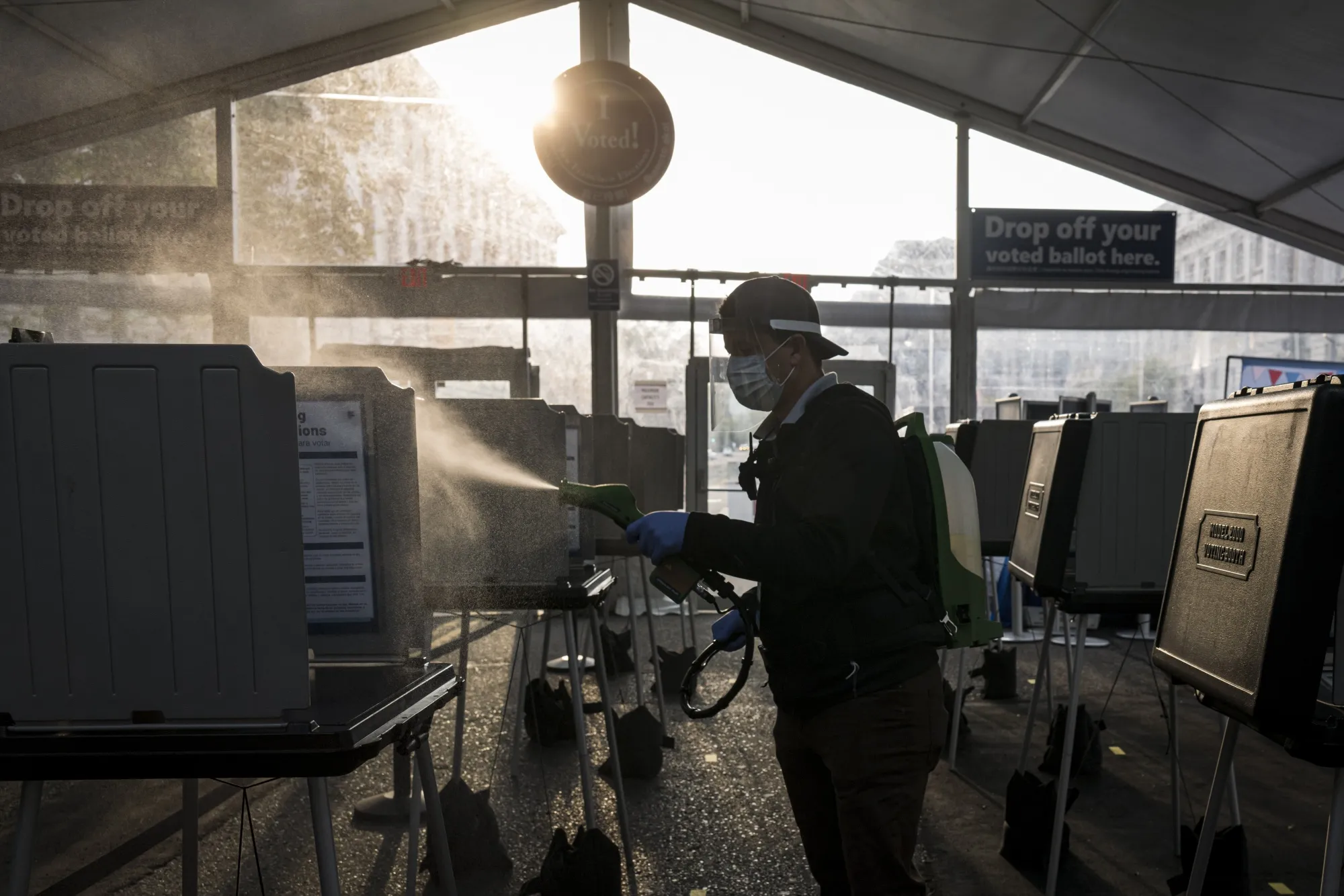A polling workers disinfects voting booths in California during early voting for the&nbsp;US Presidential Election in 2020. The race between President Joe Biden and Donald Trump took place during the height of the Covid-19 pandemic.&nbsp;