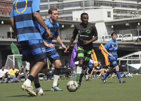 Soccer player Eddie Lewis and chef Marcus Samuelsson participate in the Tribeca/NYFEST Soccer Day - Celebrity Match during the 2012 Tribeca Film Festival at the Pier 40 on April 21, 2012.
