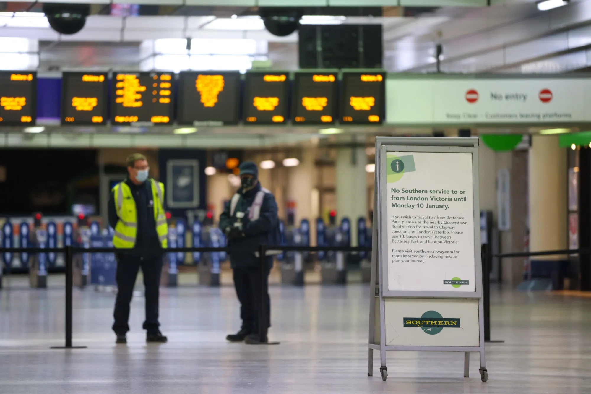 A notice informing commuters of canceled train services at London Victoria railway station.