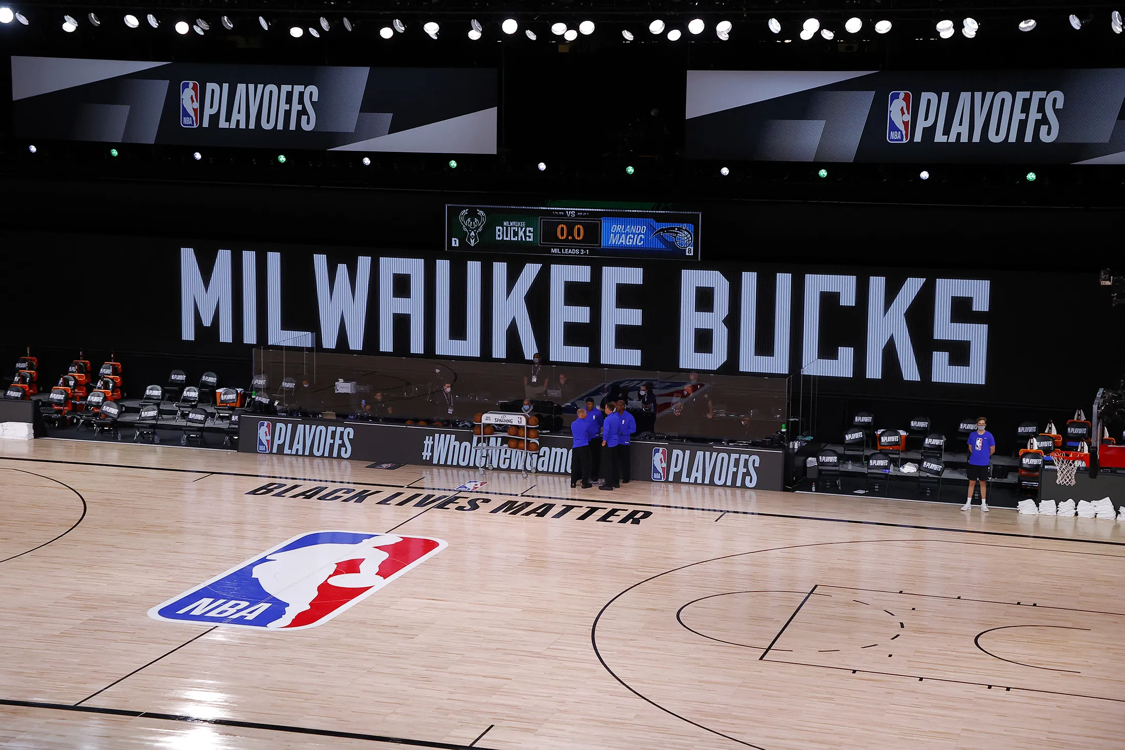 Referees huddle on an empty court at game time of a scheduled game between the Milwaukee Bucks and the Orlando Magic during the 2020 NBA Playoffs at AdventHealth Arena at ESPN Wide World Of Sports Complex on Aug. 26.