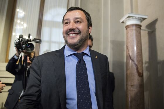 Italy Offers May Brexit Olive Branch as Grassroots Tories Revolt