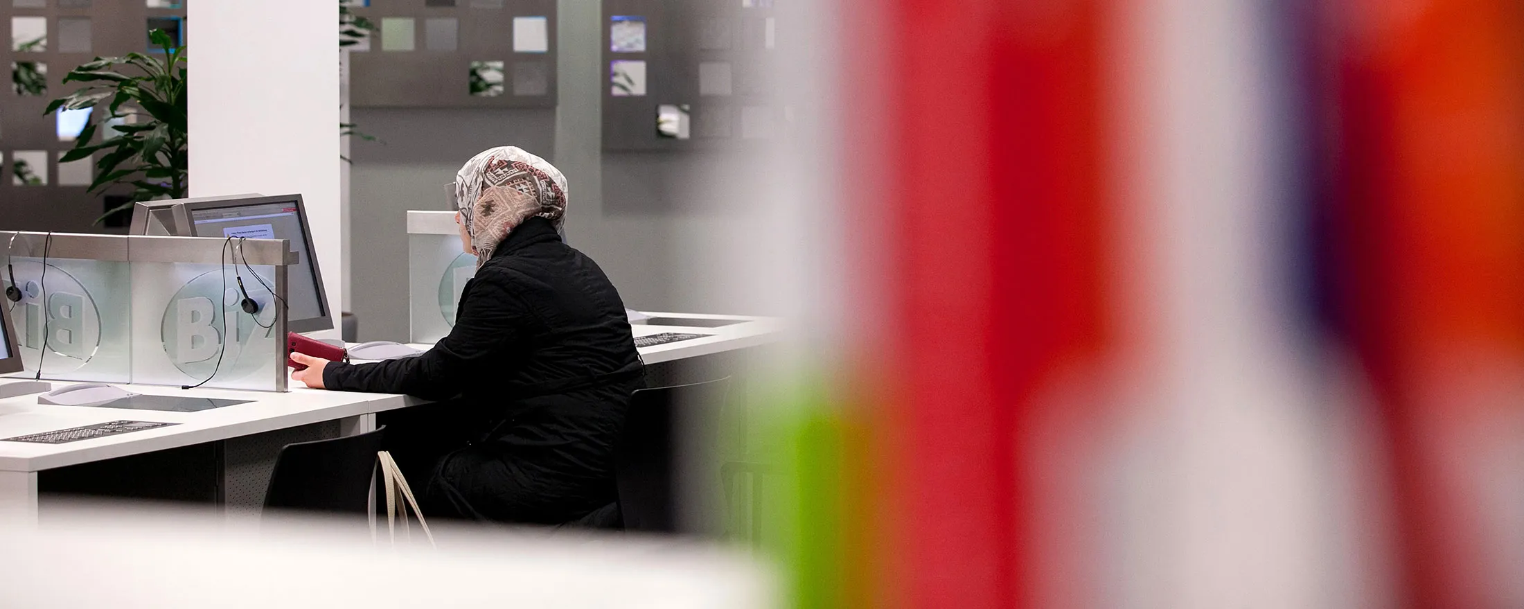 A jobseeker sits at a desktop computer inside a Agentur fuer Arbeit employment office in Stuttgart,
