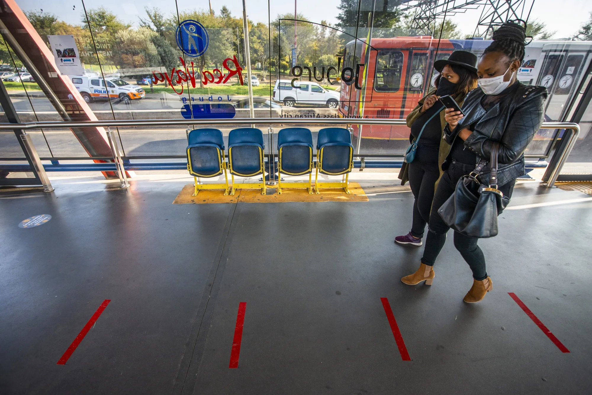 People walk through&nbsp;Rea-Vaya Thokoza Park bus station in Johannesburg.
