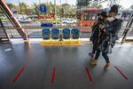 People walk through Rea-Vaya Thokoza Park bus station in Johannesburg.