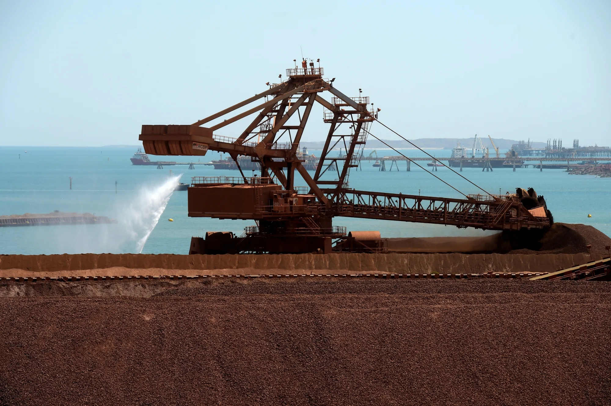 Iron ore stockpiles waiting to be transported at Rio Tinto Group's port facility in Karratha, Western Australia.