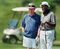 President Clinton and friend Vernon Jordan watch as their partners putt on the 14th green at the Farm Neck Golf Club in Oak Bluffs, Mass., on Martha's Vineyard, on Aug. 5, 2000.
