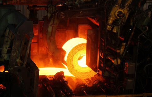 Red-Hot Rolled Steel Coil is Run through Rollers at a Steel Mill