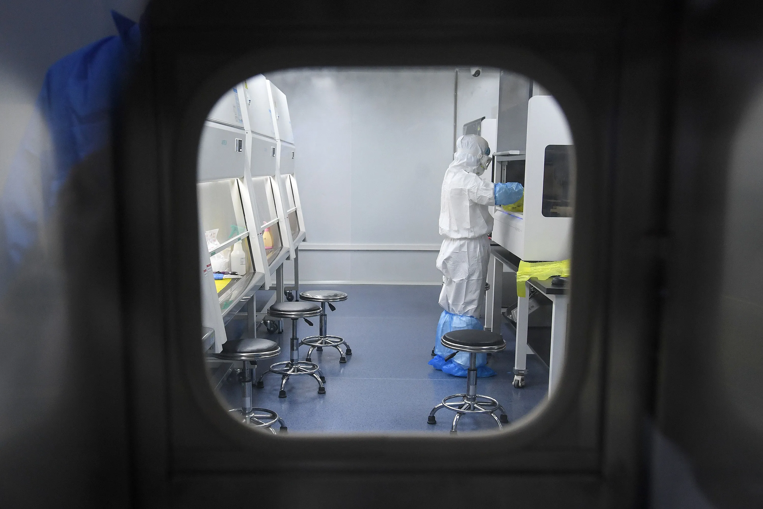 A laboratory technician works on samples from people to be tested for the new coronavirus at BGI's lab in Wuhan on Feb. 6.