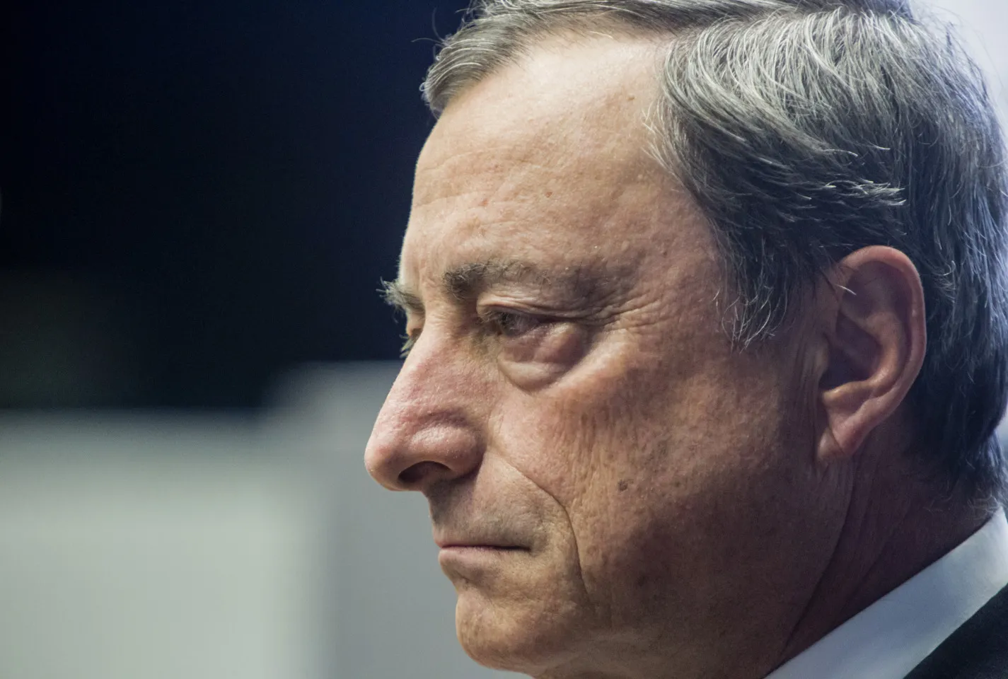 Mario Draghi, president of the European Central Bank (ECB), listens to an attendee following an artwork inauguration at the ECB's headquarters in Frankfurt, Germany, on Tuesday, Oct. 6, 2014.
