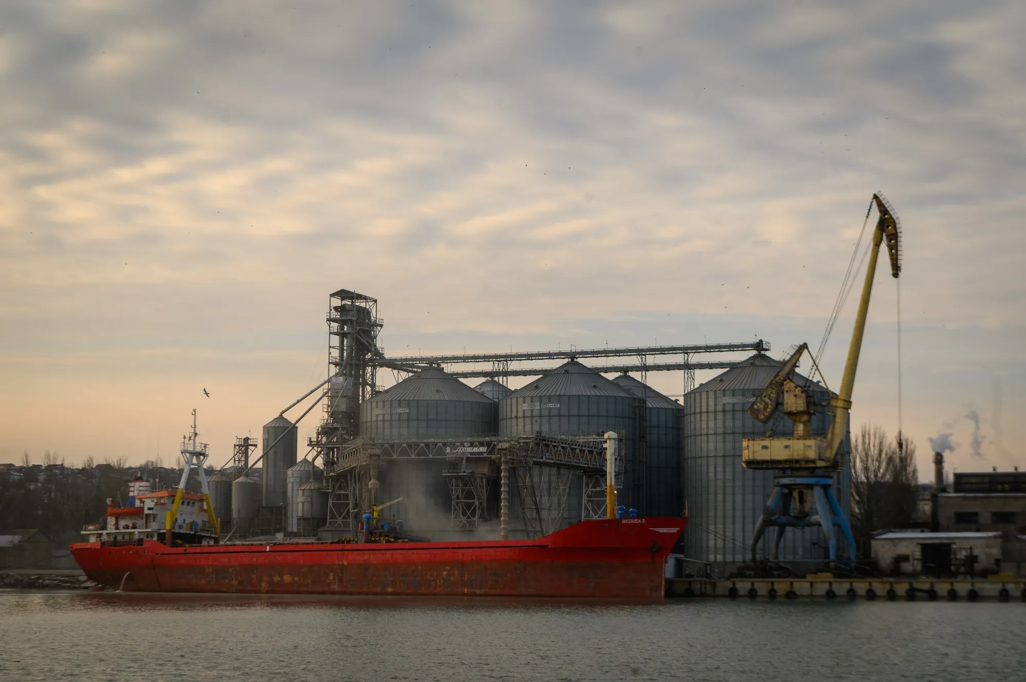 A cargo ship is loaded with grain at the Port of Mariupol in Mariupol, Ukraine, on Jan. 13.