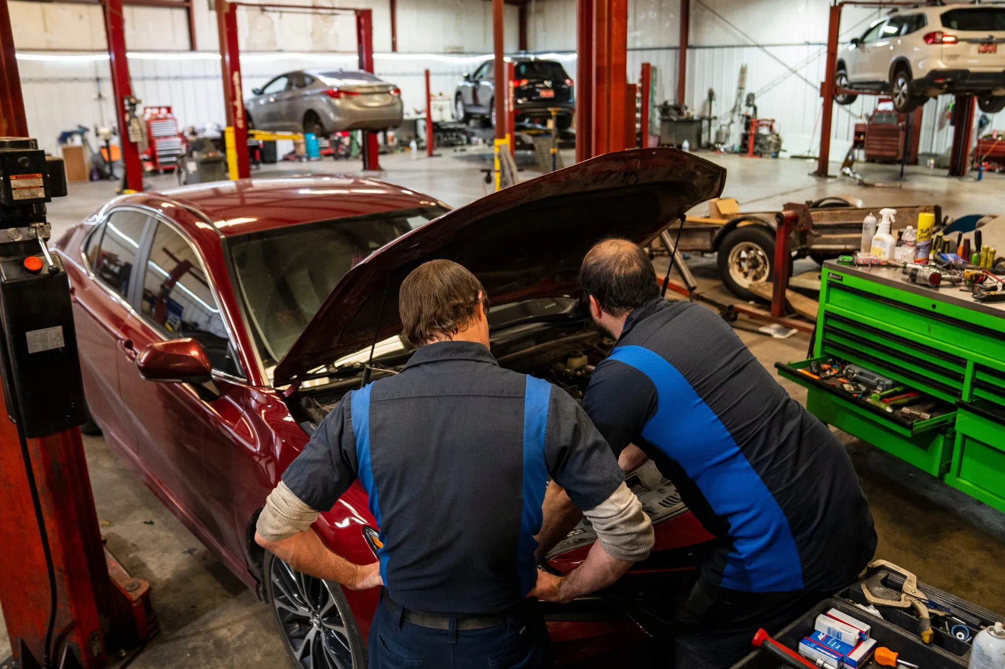 Mechanics work on a vehicle at an automotive shop in Oklahoma City.