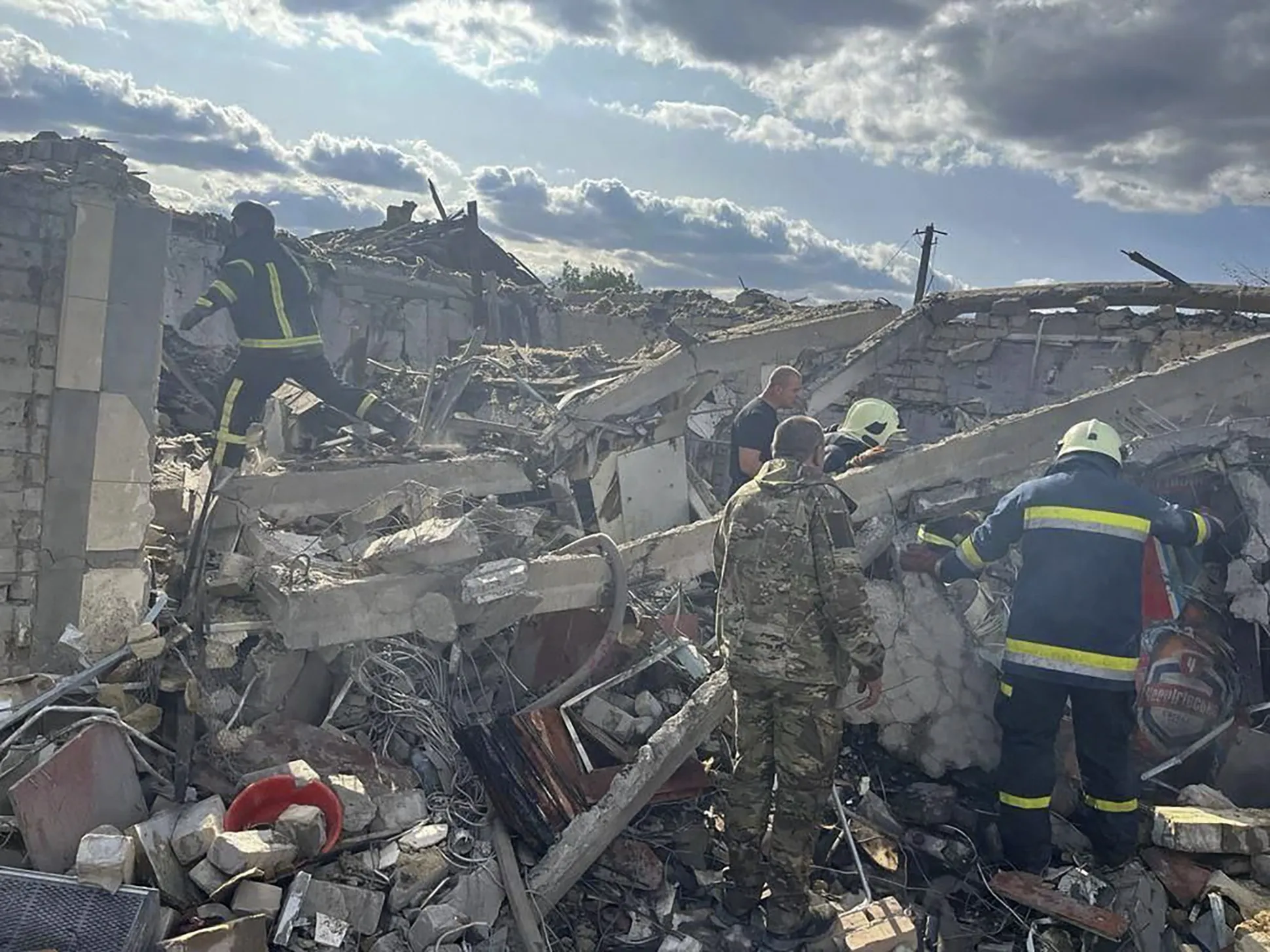 Emergency workers search the victims of a Russian rocket attack&nbsp;in Hroza near Kharkiv, Ukraine on Oct. 5.