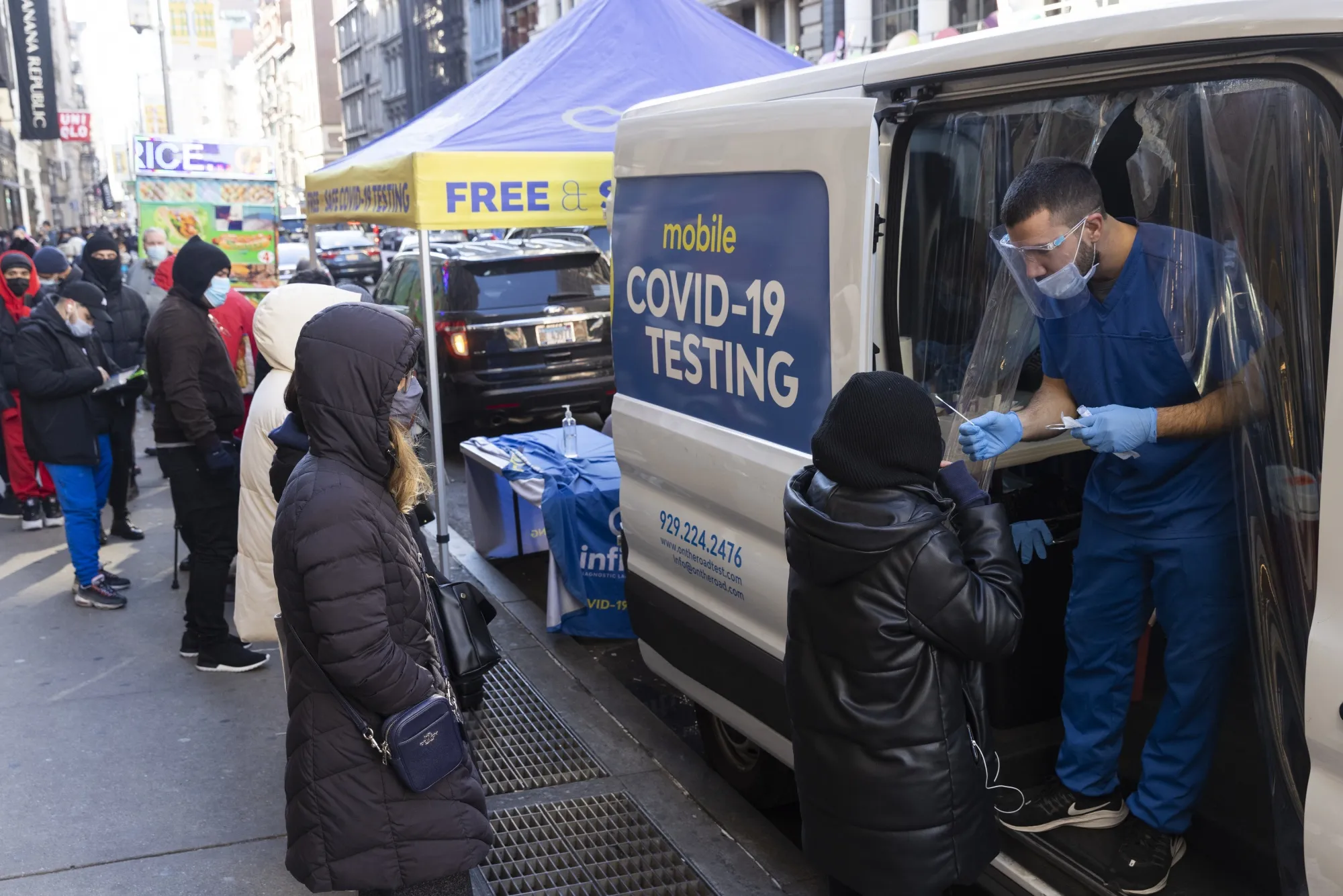 A healthcare worker administers a Covid-19 test at a mobile testing site in the SoHo neighborhood of New York, on&nbsp;Dec. 20.