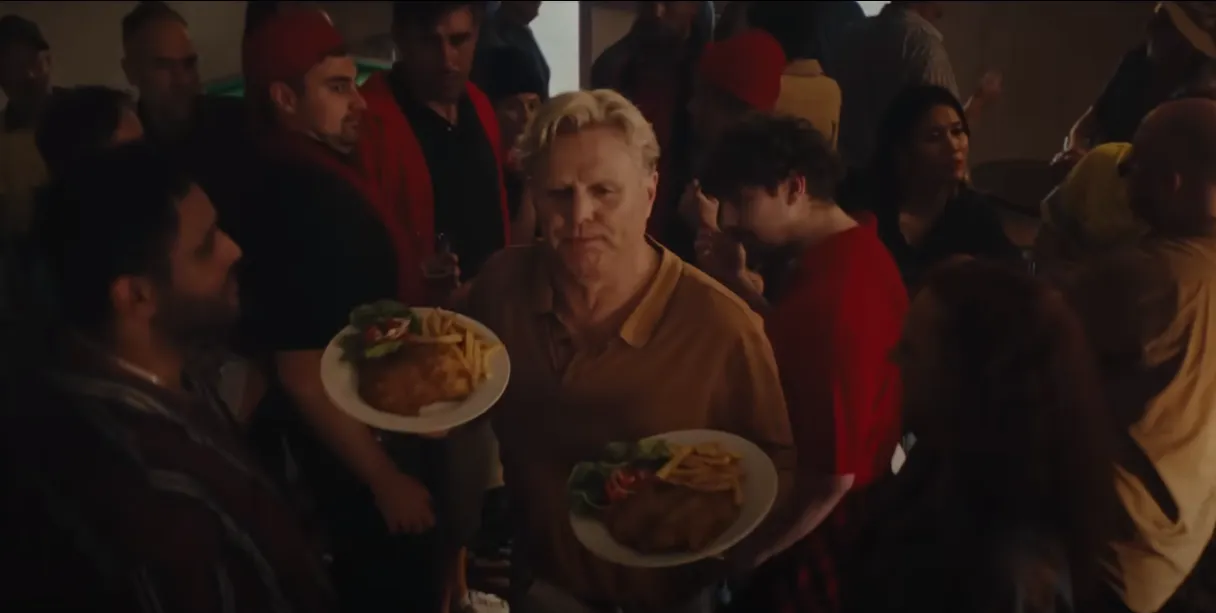 AFL great Dermott Brereton in a scene from Kia’s TV ad for its new Australian ute.