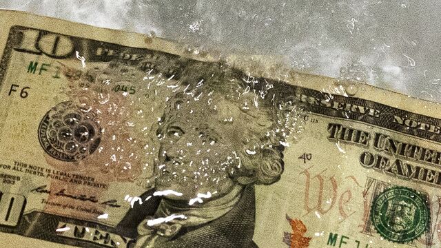 A staged close up abstract photo of money floating in water. This is an interpretation of “clean money”.