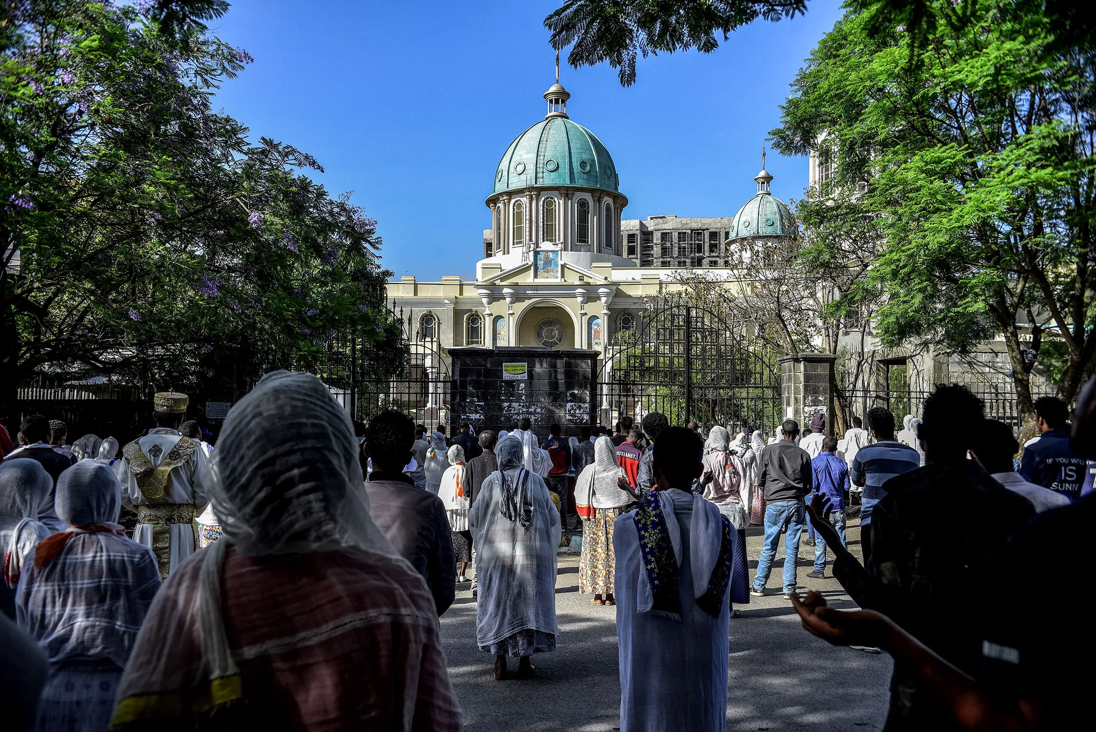 Orthodox Christians pray outside the closed Medhane Alem Cathedral as the government recommends&nbsp;to avoid large gatherings to curb the spread of the Covid-19 in Addis Ababa, Ethiopia, on April 5.