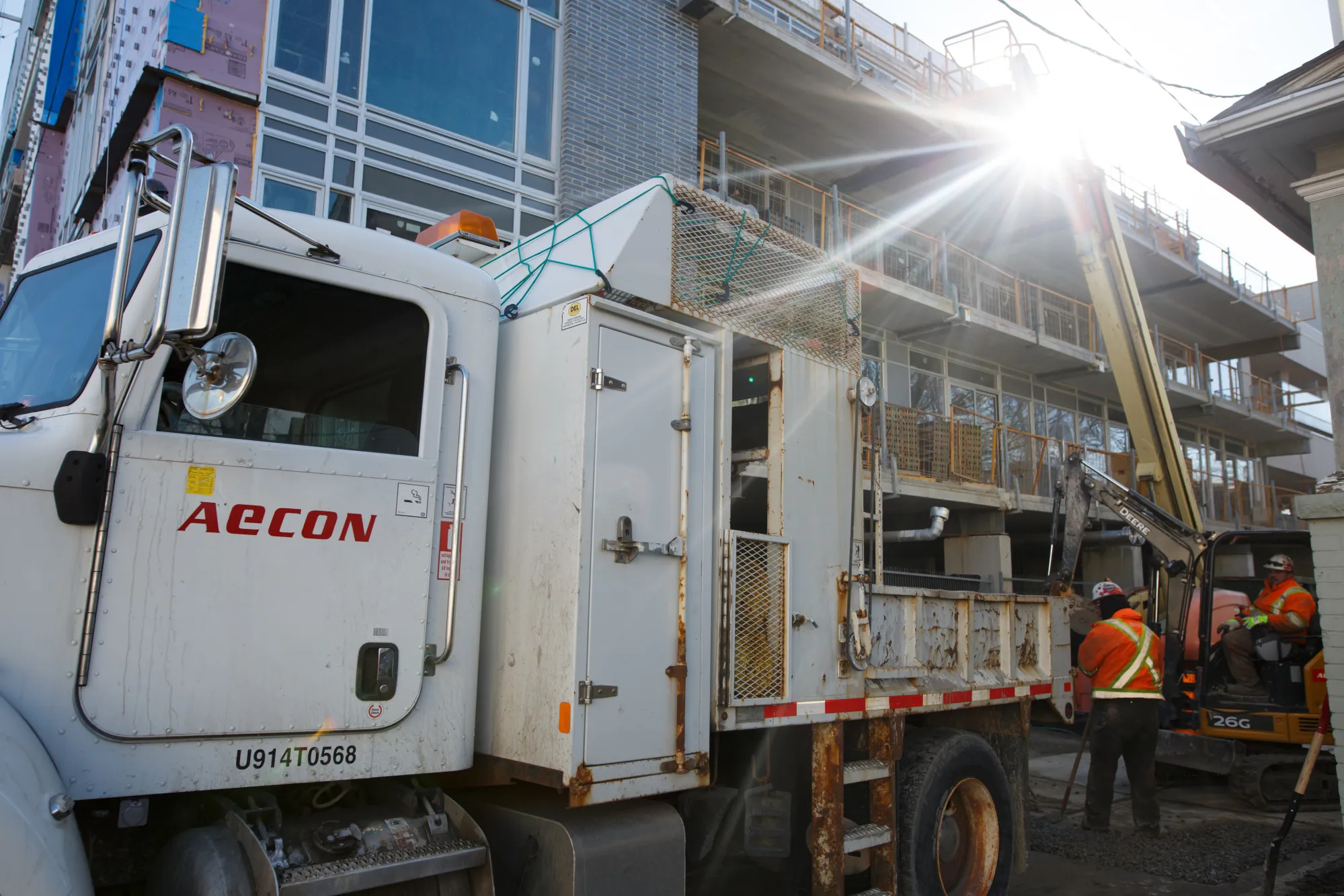 Aecon Group Inc. signage is displayed on a truck parked at a construction site in Toronto, Ontario, Canada.