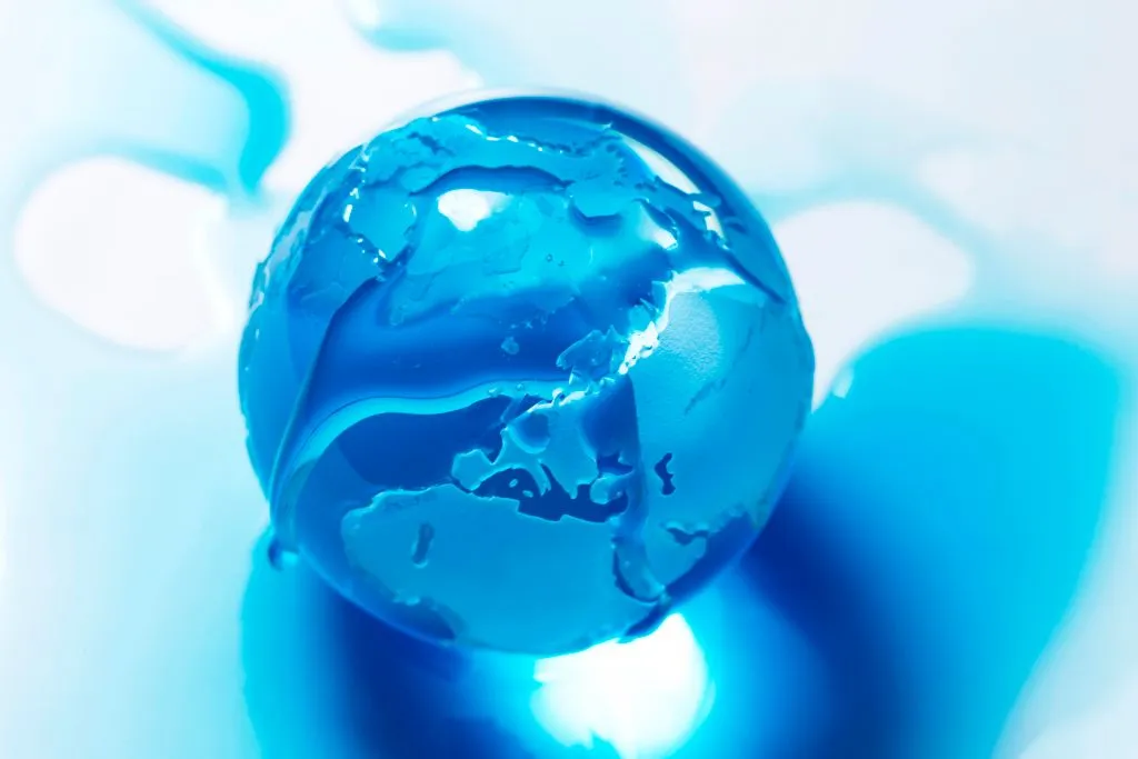 An illustration made in Paris on November 8, 2015 shows an Earth globe made of glass and covered in blue liquid. Earth has heated up by one degree Celsius (1.6 degrees Fahrenheit), Britain's weather office said on November 9, as greenhouse gases hit record levels.