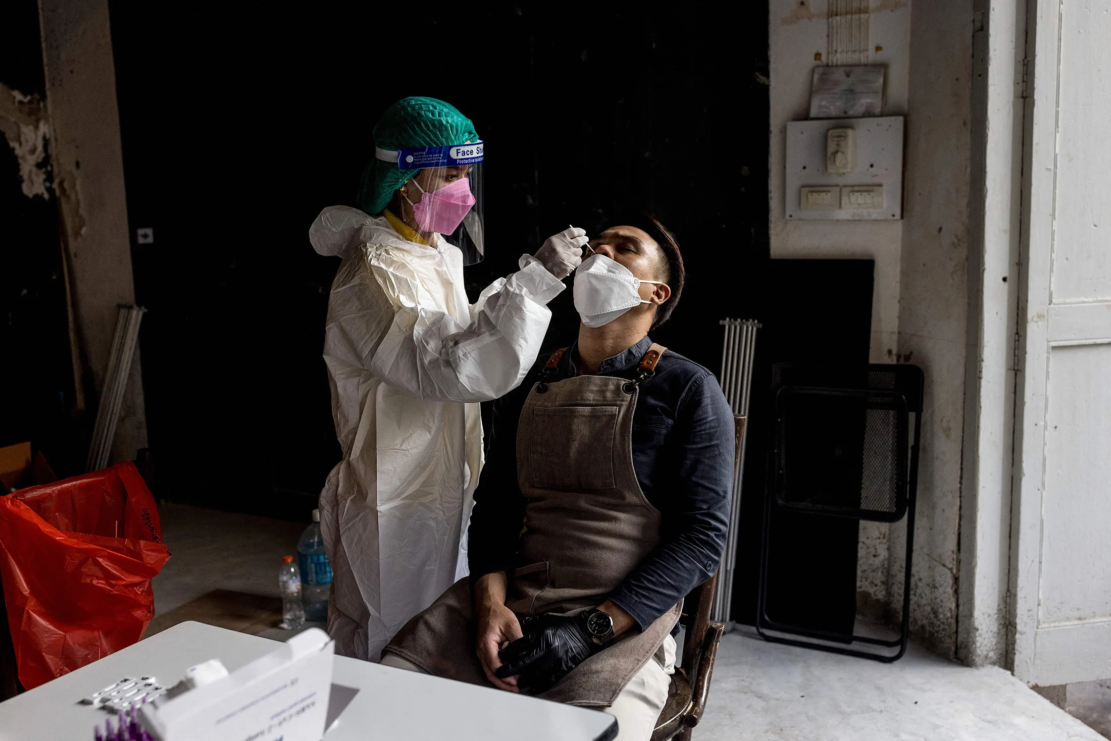 A bar worker receives a Covid-19 nasal swab test before starting his shift in Bangkok on Jan. 6.