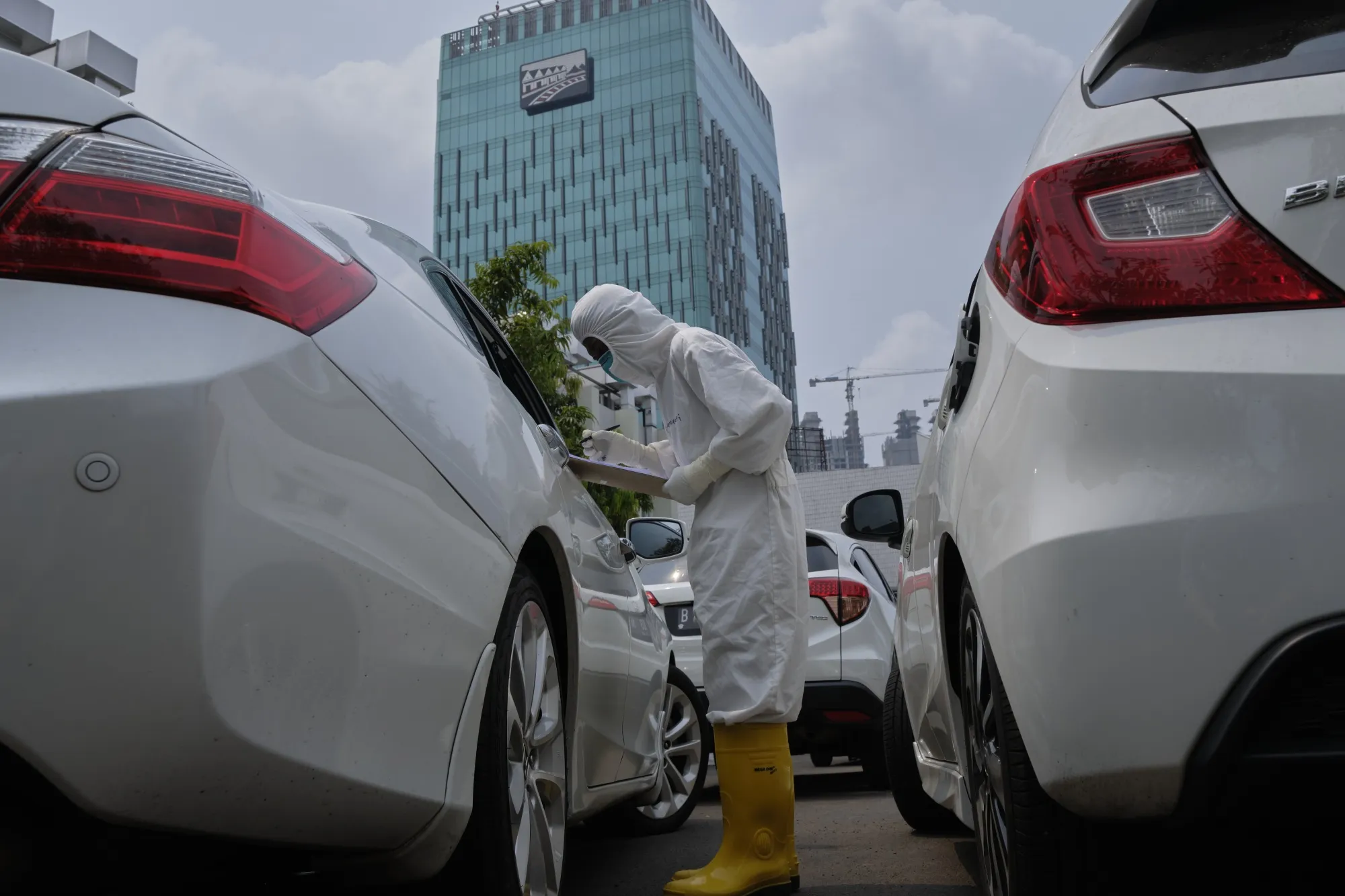 A medical worker speaks with a driver at a drive through Covid-19 testing site in Jakarta on Sept. 14.