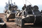 Armored personnel carriers arrive from a landing ship during an amphibious military exercise held by army corps and naval infantry units of the Russian Black Sea Fleet in Crimea on Oct. 18.