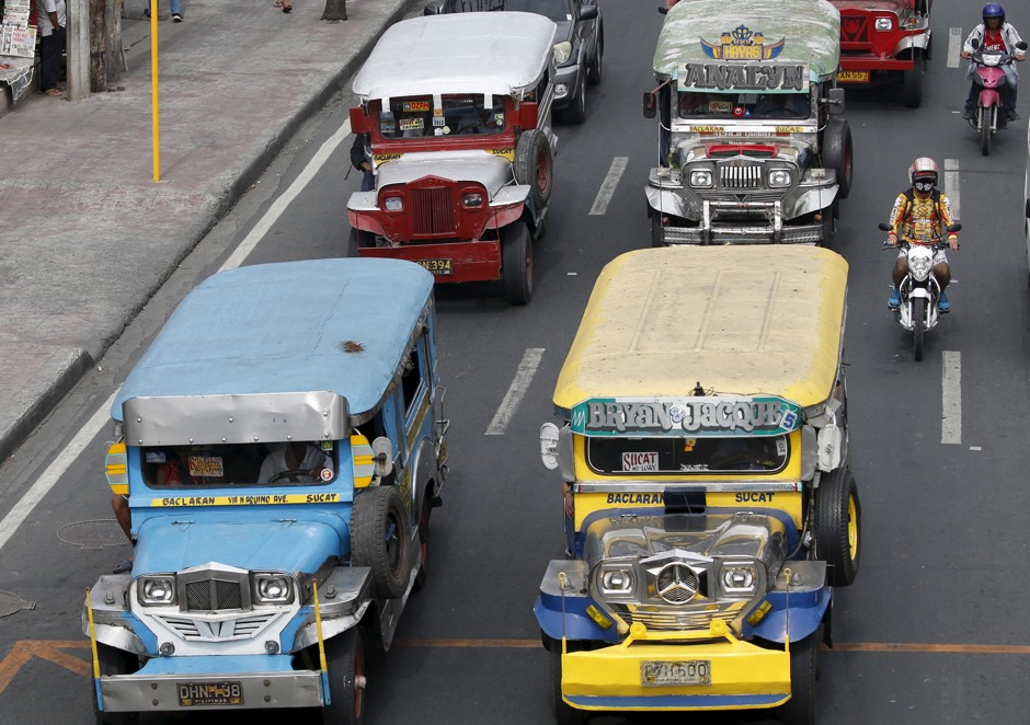 Jeepneys parade down a Manila street.