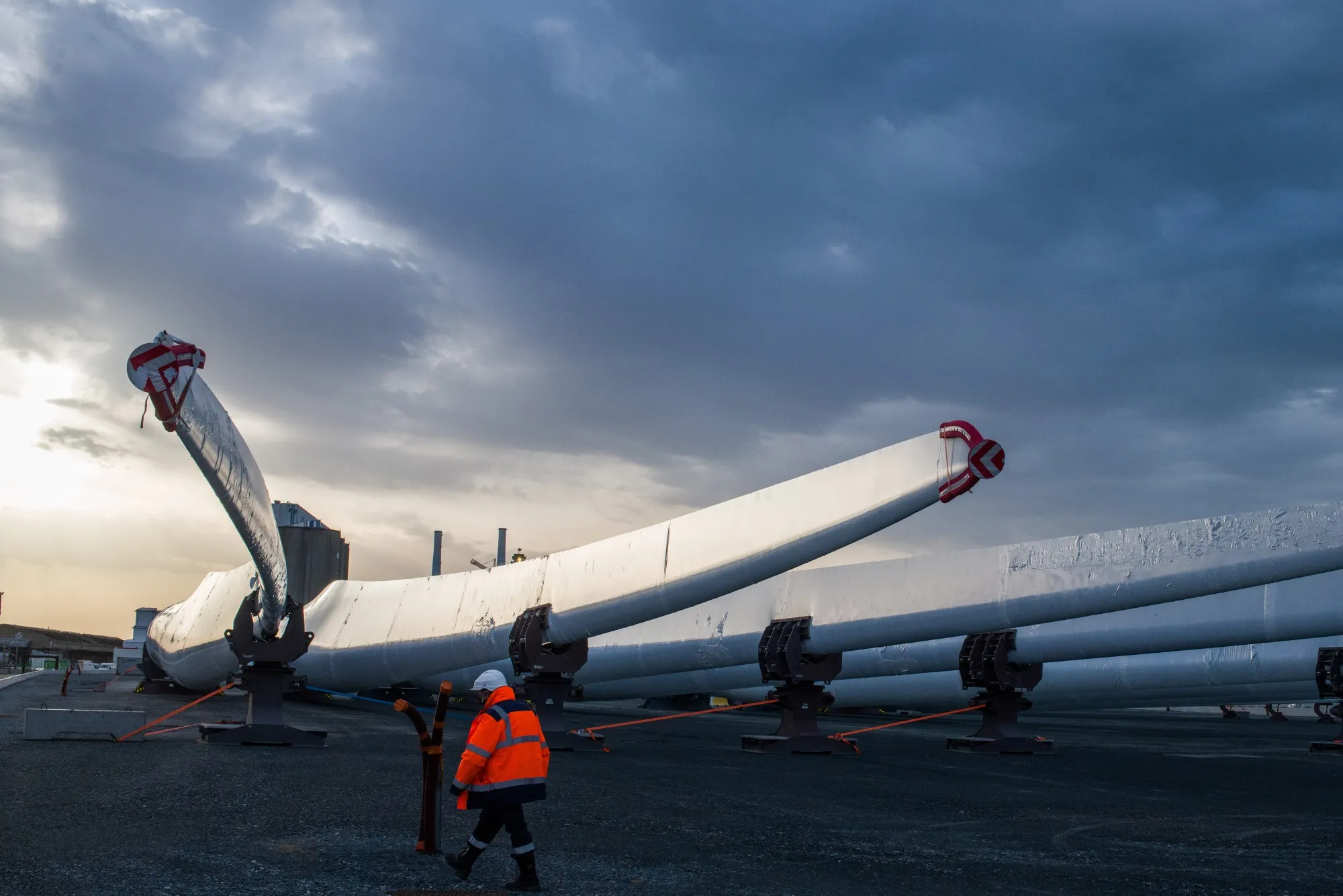 A worker passes wind turbine blades at the Siemens Gamesa Renewable Energy SA plant