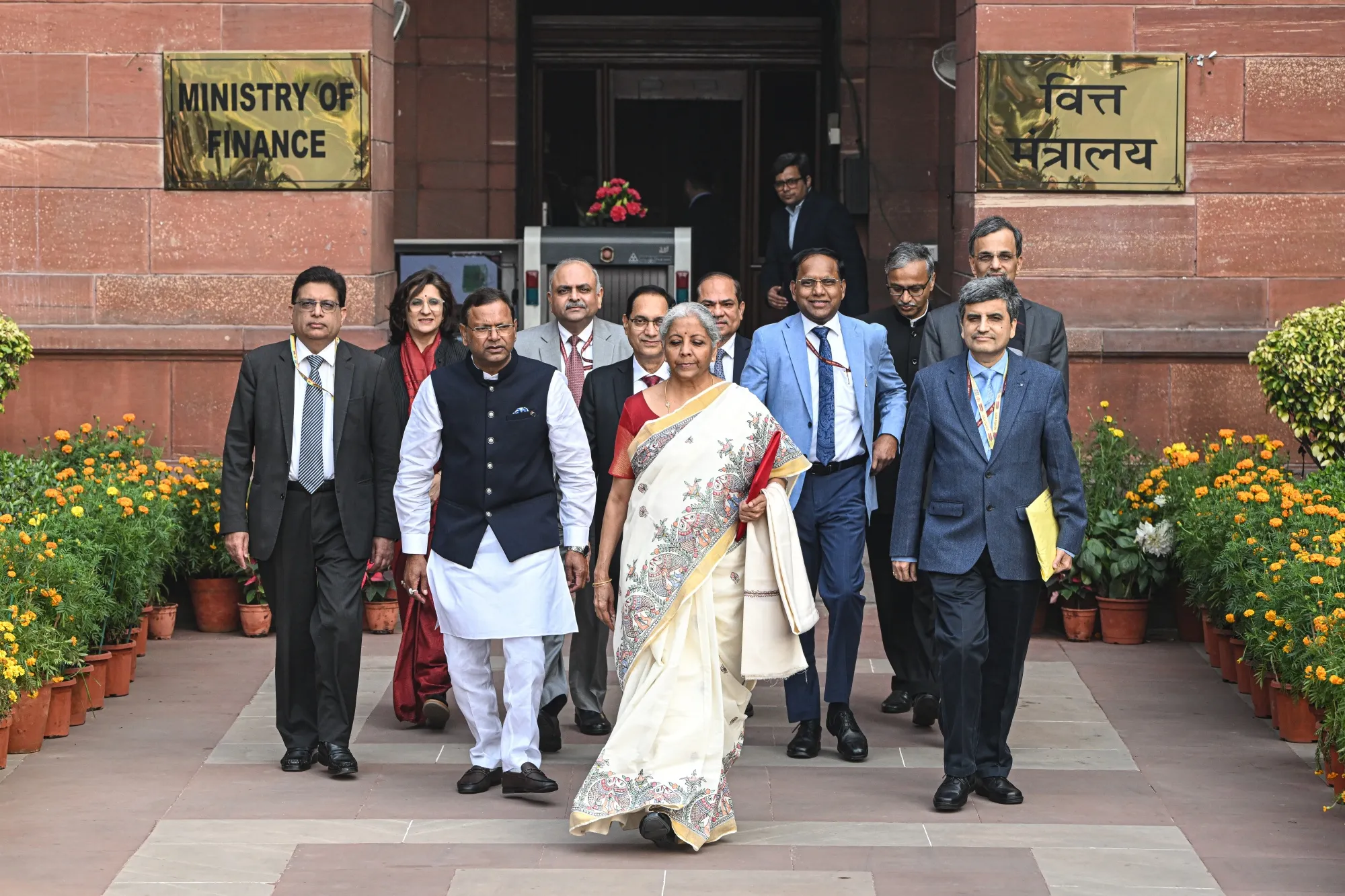 Nirmala Sitharaman, center, and other members of finance ministry leave the ministry to present the budget at the parliament in New Delhi.