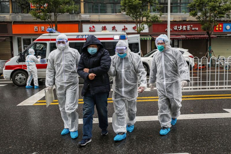 Medical staff accompany a patient to a hospital in Wuhan, Jan. 2020. Photo/ AFP via Getty Images