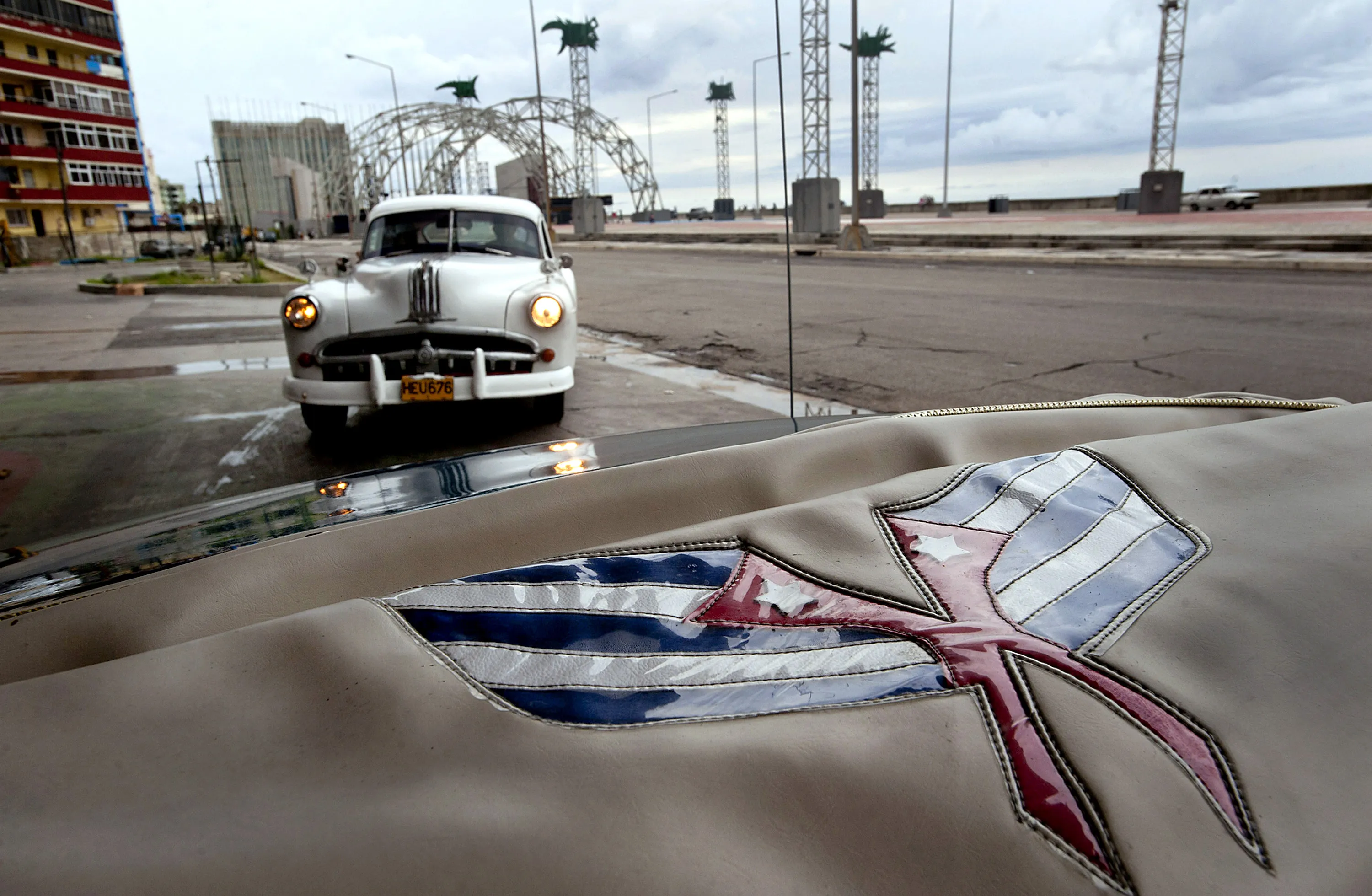 Embroidered Cuban flags on a 1954 Chevrolet convertible taxi in Havana.
