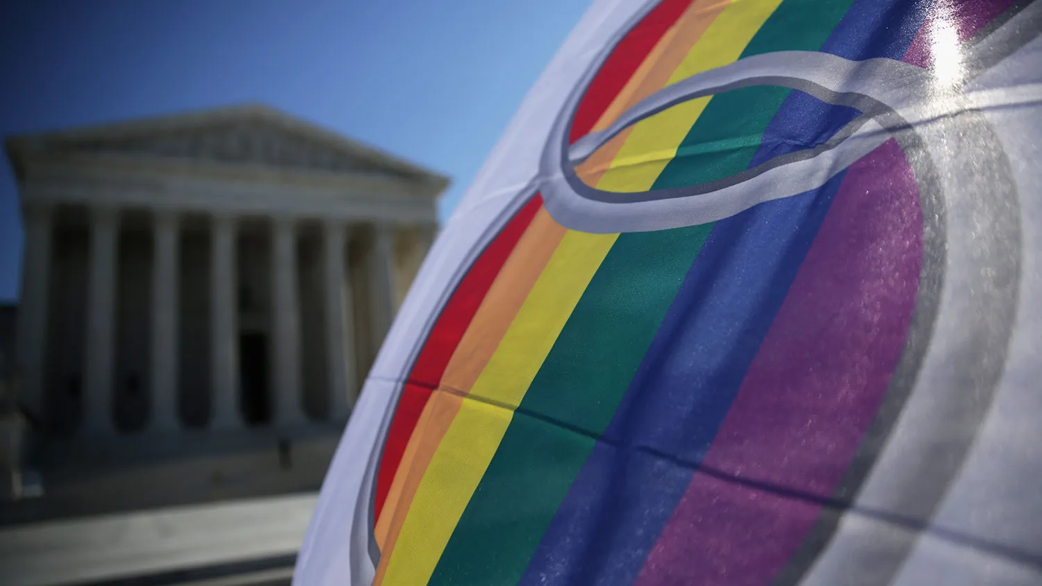 An activist flies a 'marriage pride flag' outside the U.S. Supreme Court January 9, 2015 in Washington, DC.
