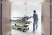 Nurse wheeling patient to surgery OR