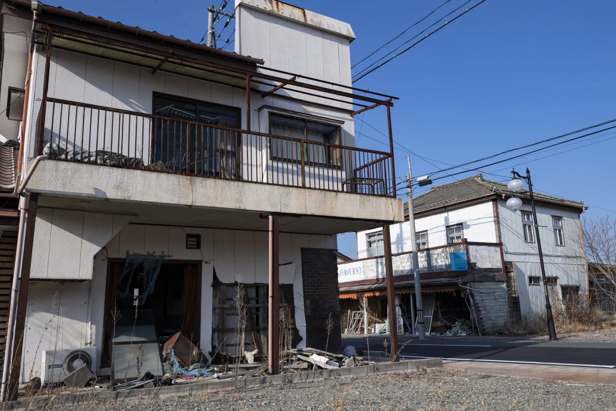 Destroyed and abandoned houses line the street in Futaba, in Mar 2022.&nbsp;