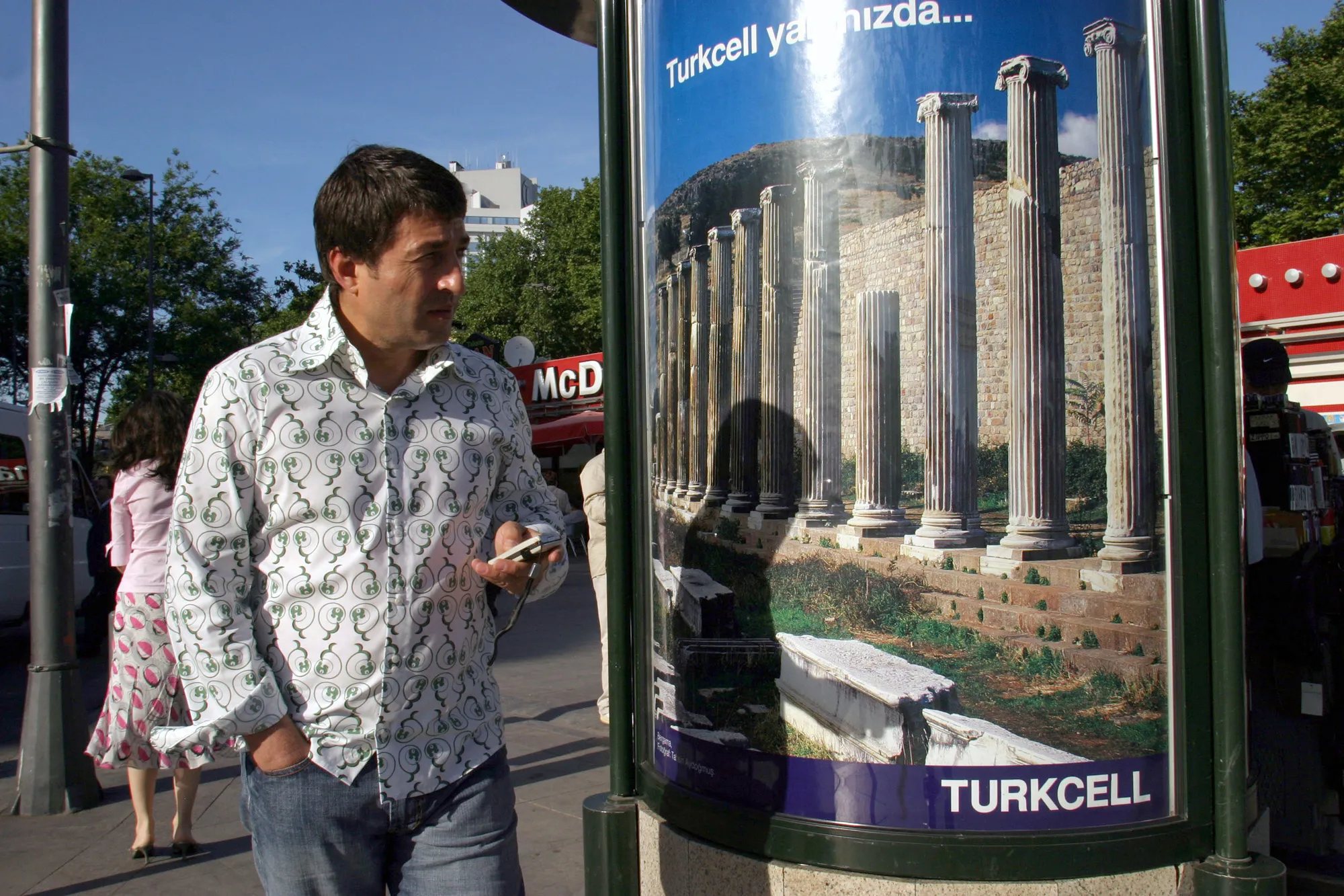 A pedestrian uses his mobile phone in front of a Turkcell advertisment in&nbsp;Istanbul.