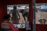 People enquire at a Covid-19 testing site in Mumbai on April 27.