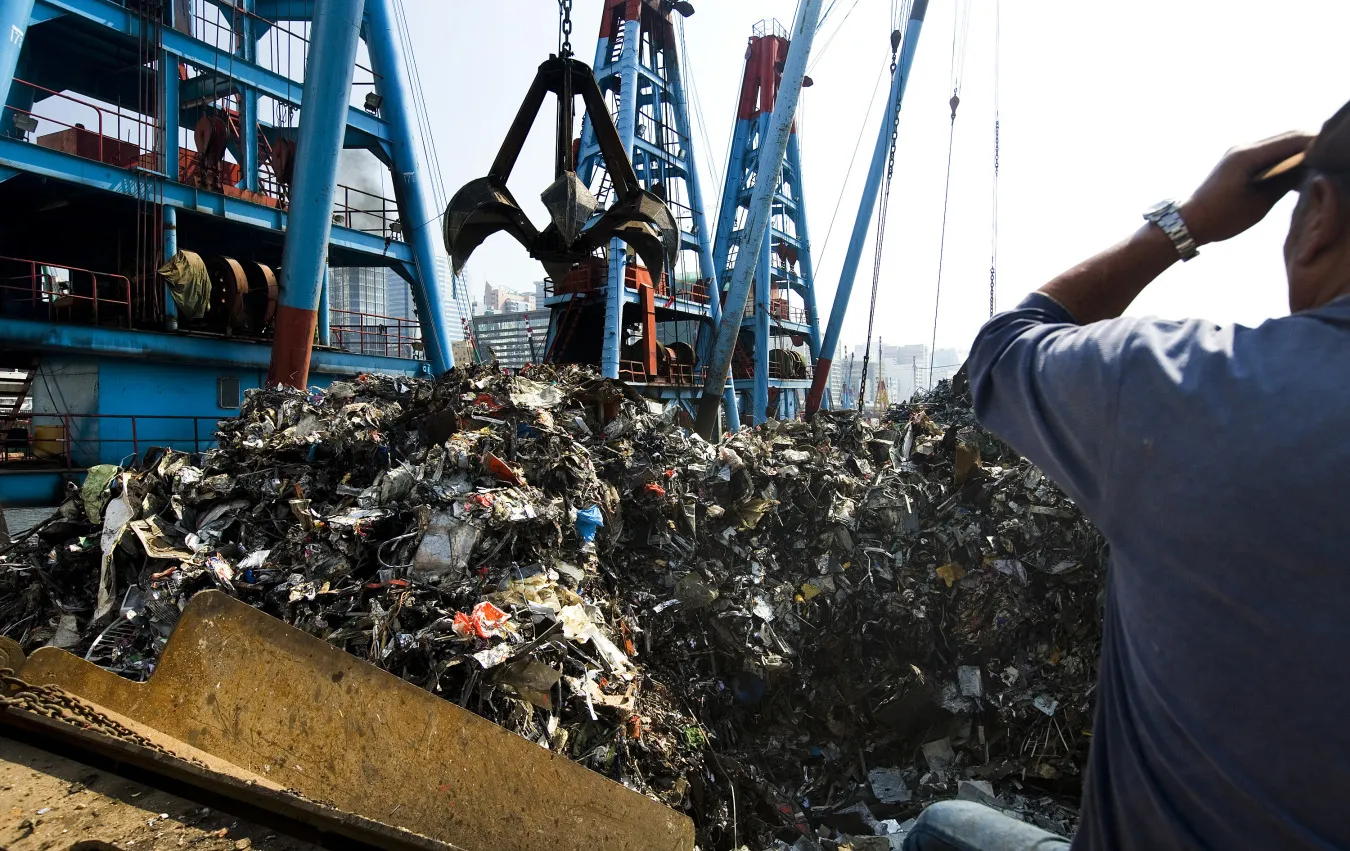 Scrap metal being loaded onto a barge in Hong Kong.
