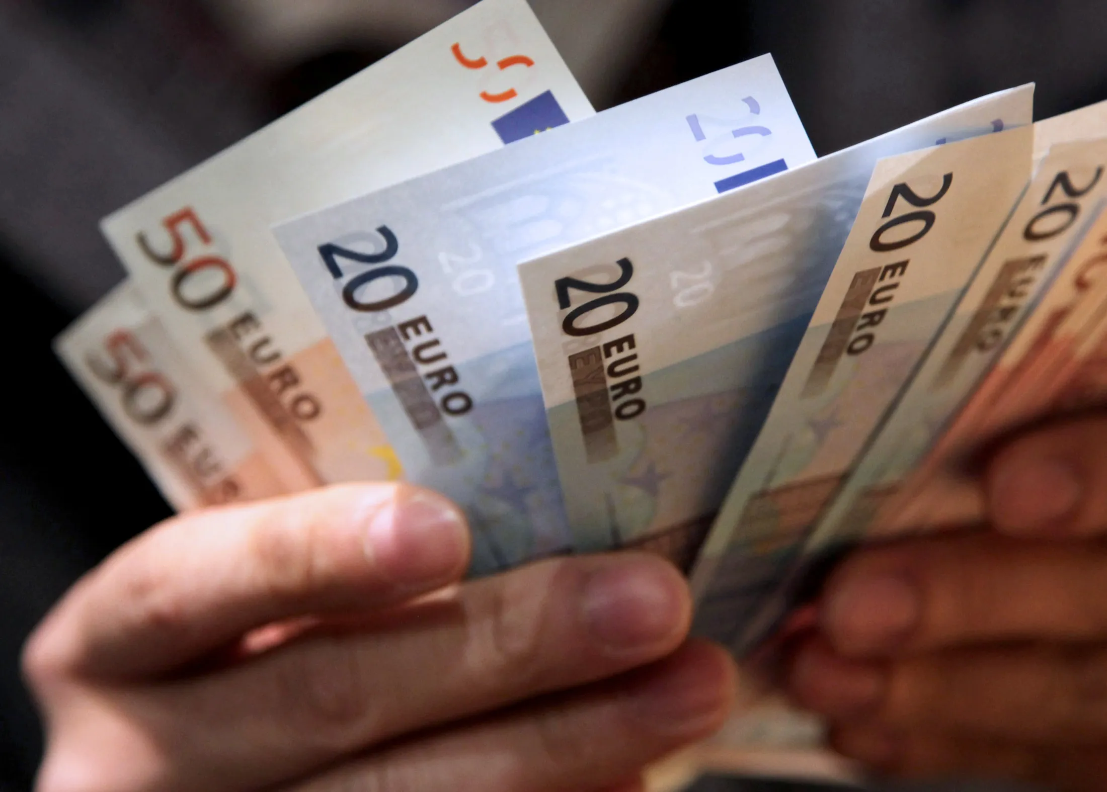 A man counts euro notes in this arranged photograph in Tokyo, Japan, on Thursday, Dec. 29, 2011. The euro weakened to a decade low against the yen before Italy auctions as much as 8.5 billion euros ($11 billion) of debt. European shares and U.S. equity-index futures climbed.
